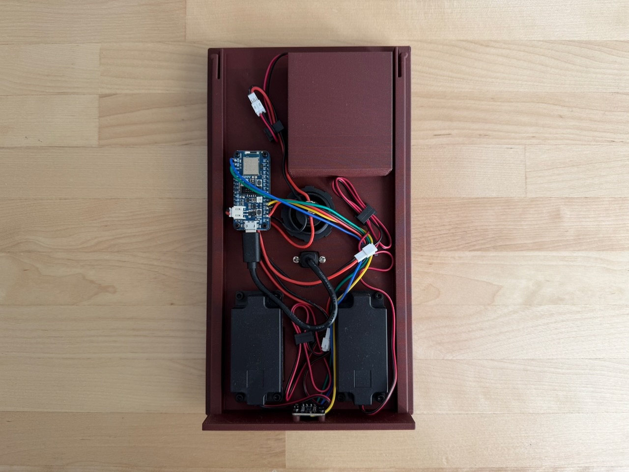 Photo of the back of the enclosure with the electronics mounted to it. BleatBox electronics assembled into the back